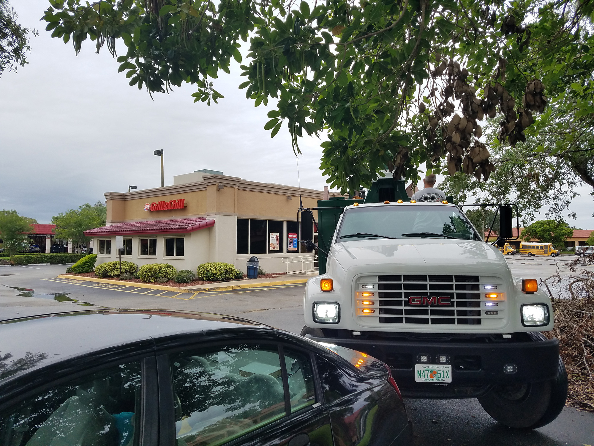 a truck is parked in front of a restaurant.