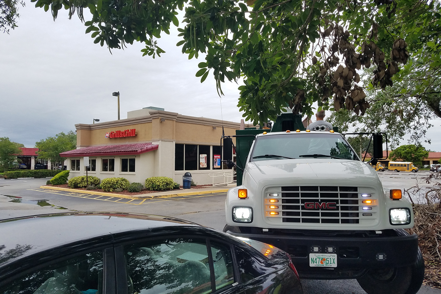 a large truck is parked in front of a restaurant.