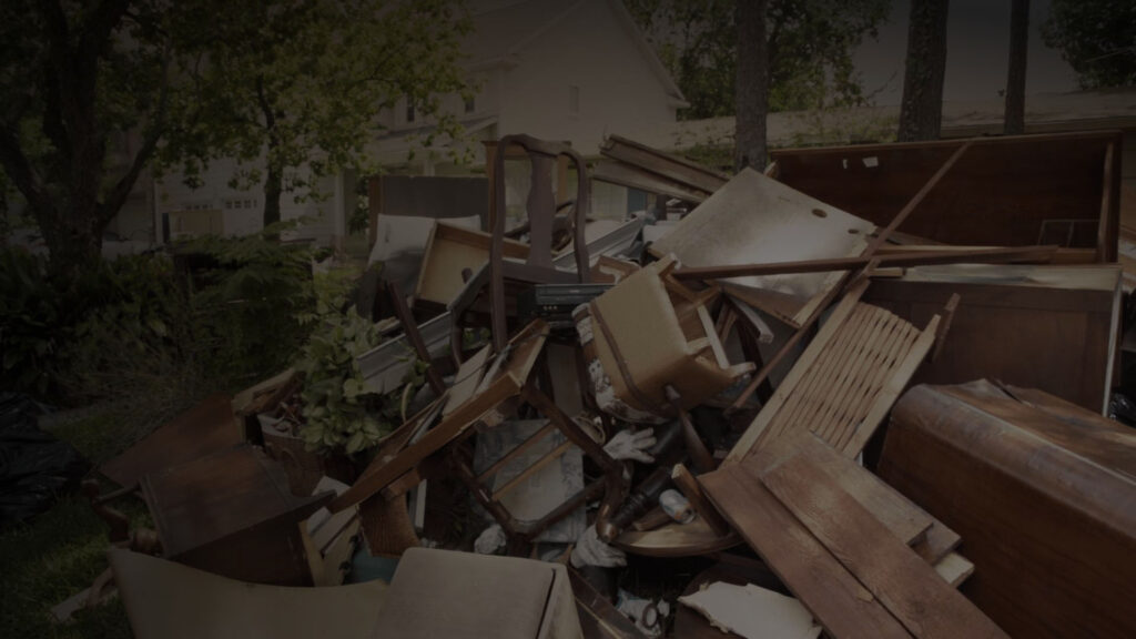 Residential junk removal of old furniture in a yard.